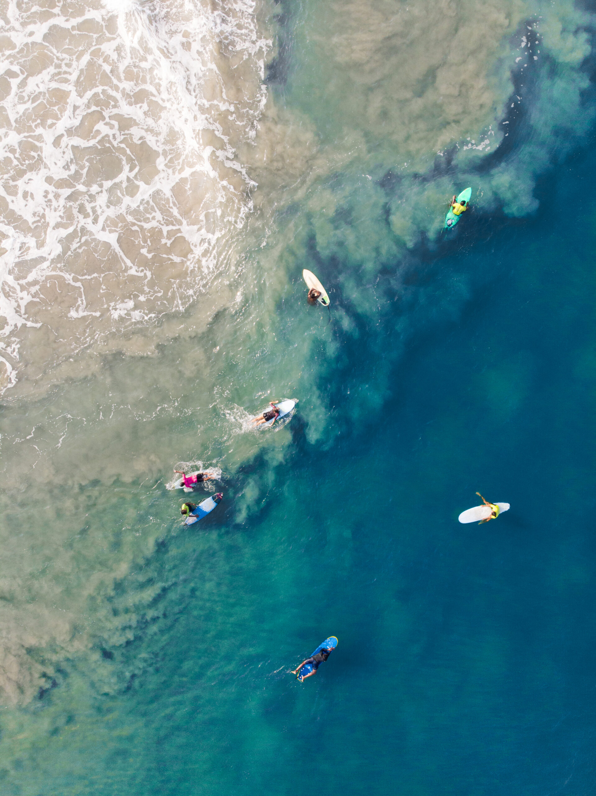People with surfboards in the ocean