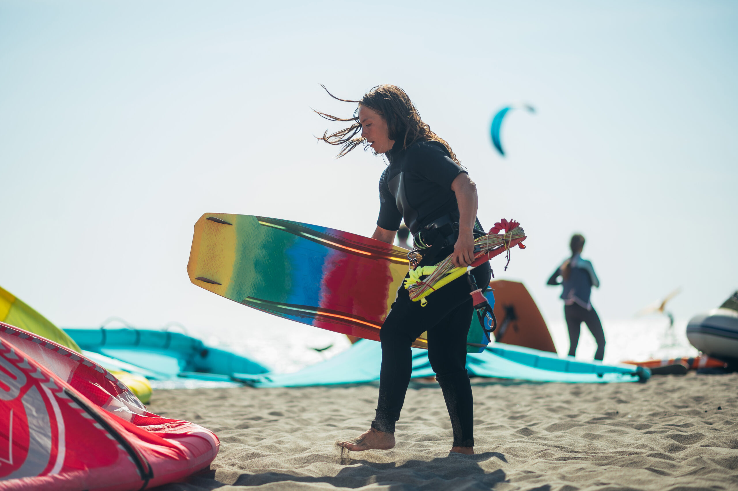 Woman holding kiteboard and control bar