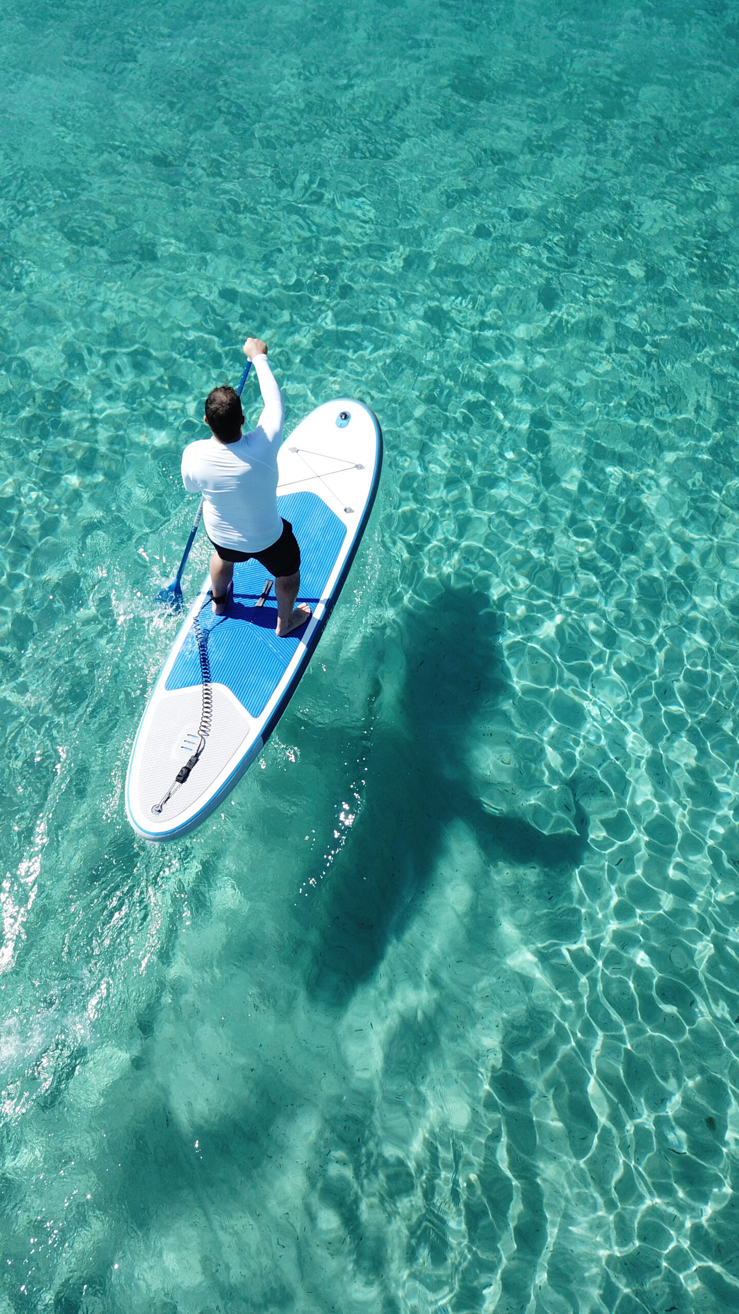 Stand-up paddle boarding in calm tropical water