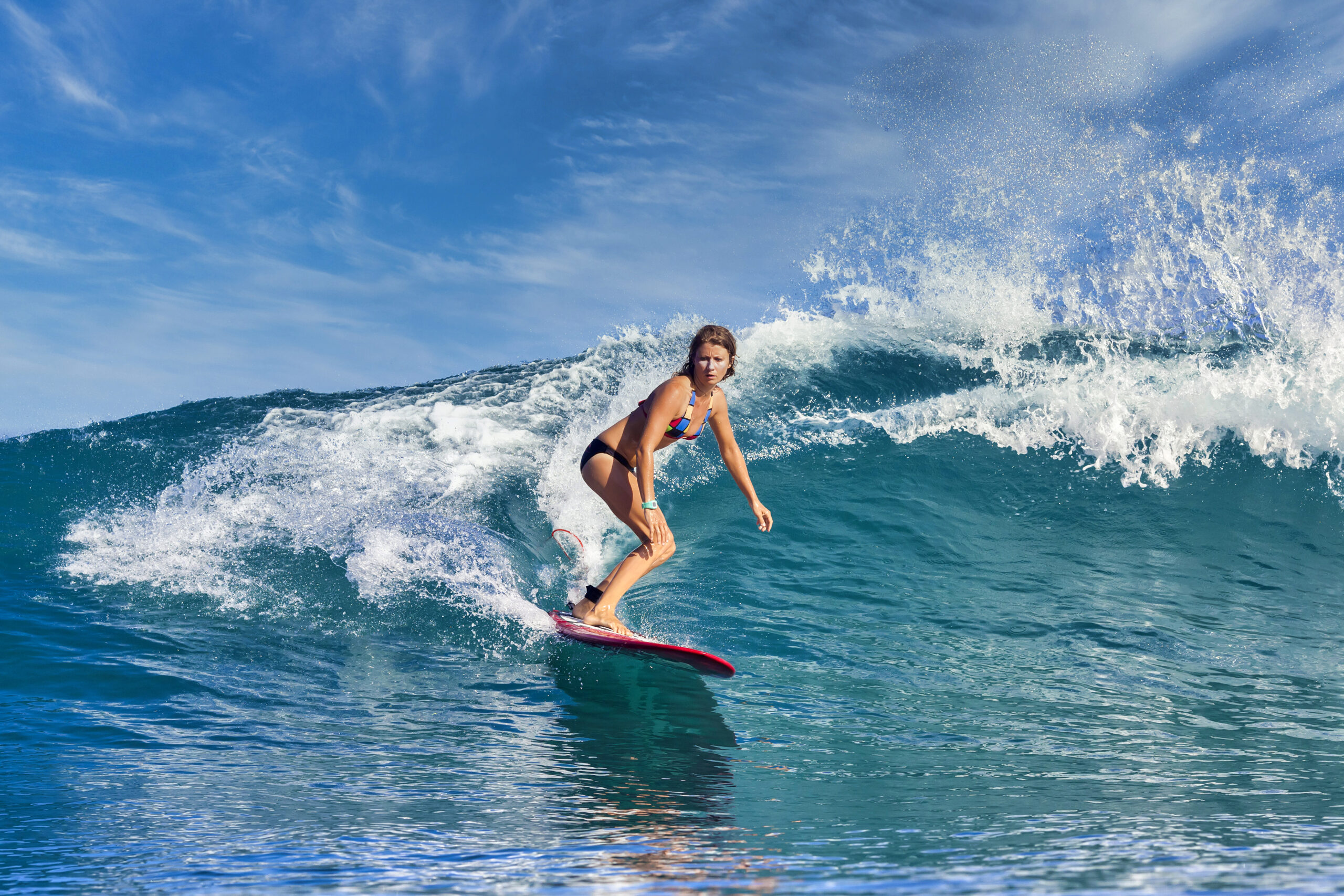 Female surfer riding a wave in Cabarete