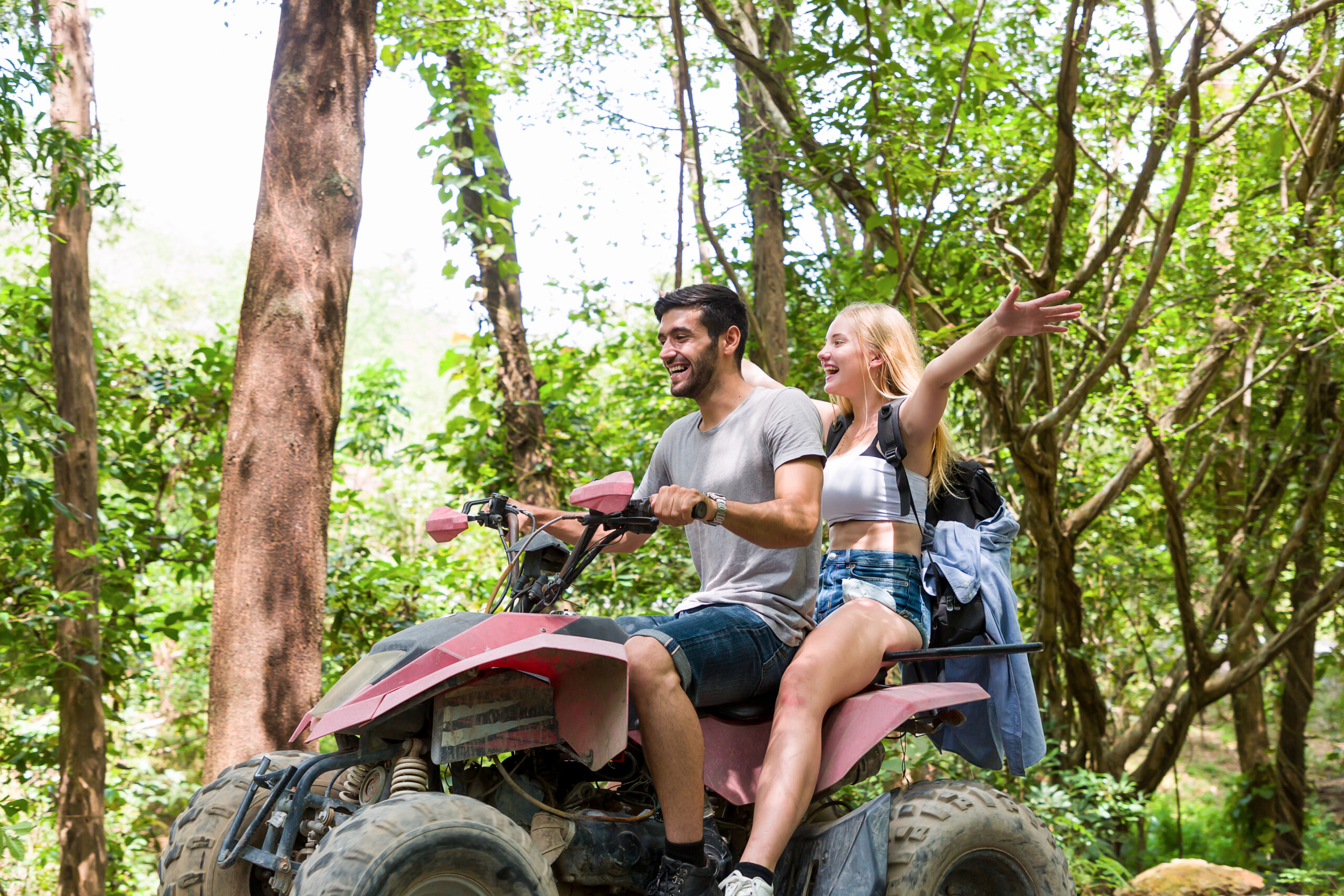 Couple riding an ATV on an off-road adventure